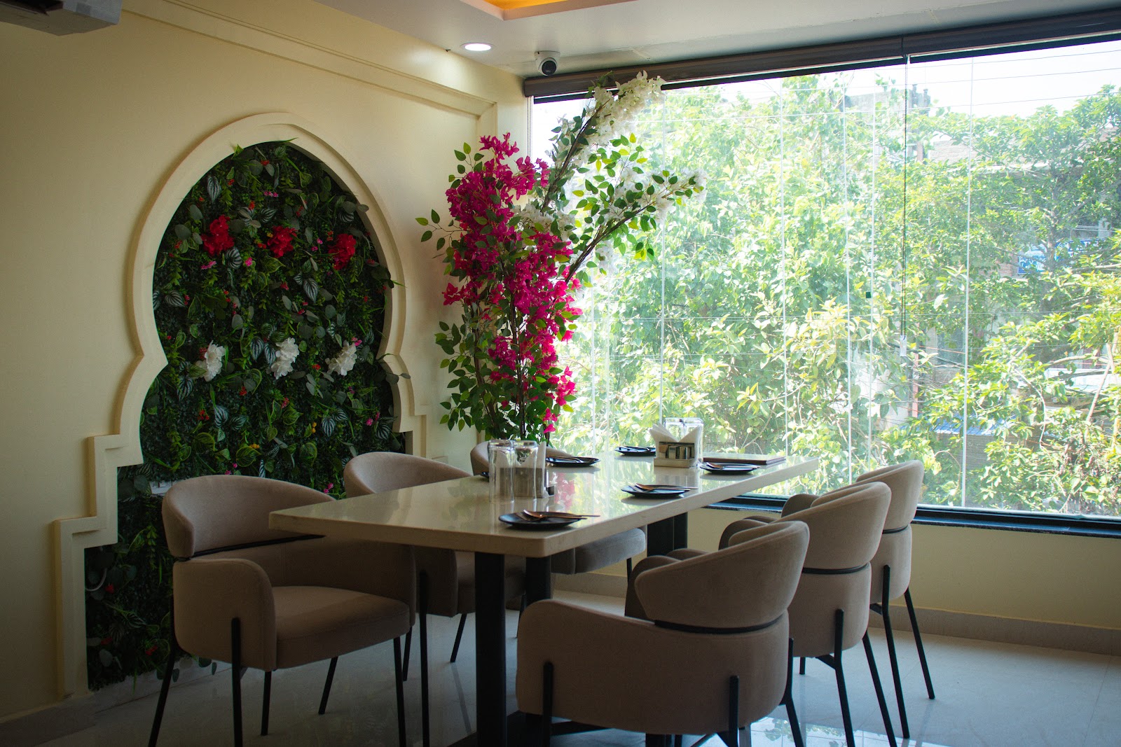 Window-side restaurant seating at Mithila Heritage